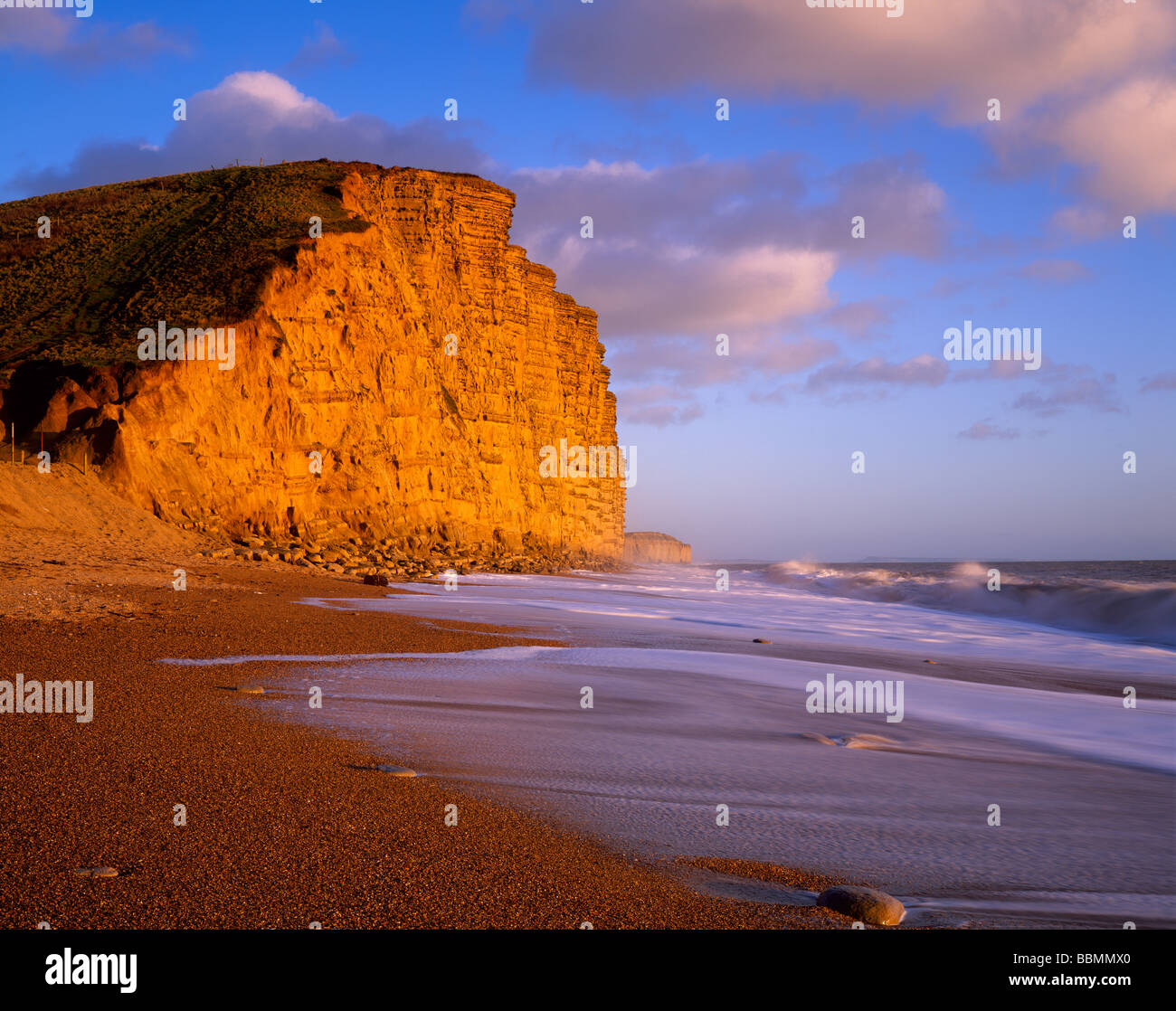 The shingle beach and East Cliff at West Bay near Bridport on the Dorset Jurassic Coast, England. Stock Photo