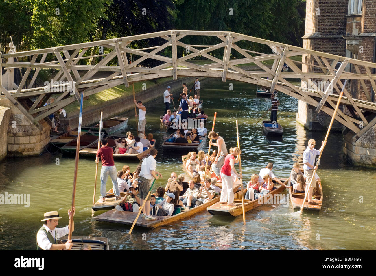 Cambridge summer; Punting on the River Cam at Newtons Mathematical Bridge, Queens College, Cambridge, UK on a sunny summers day Stock Photo