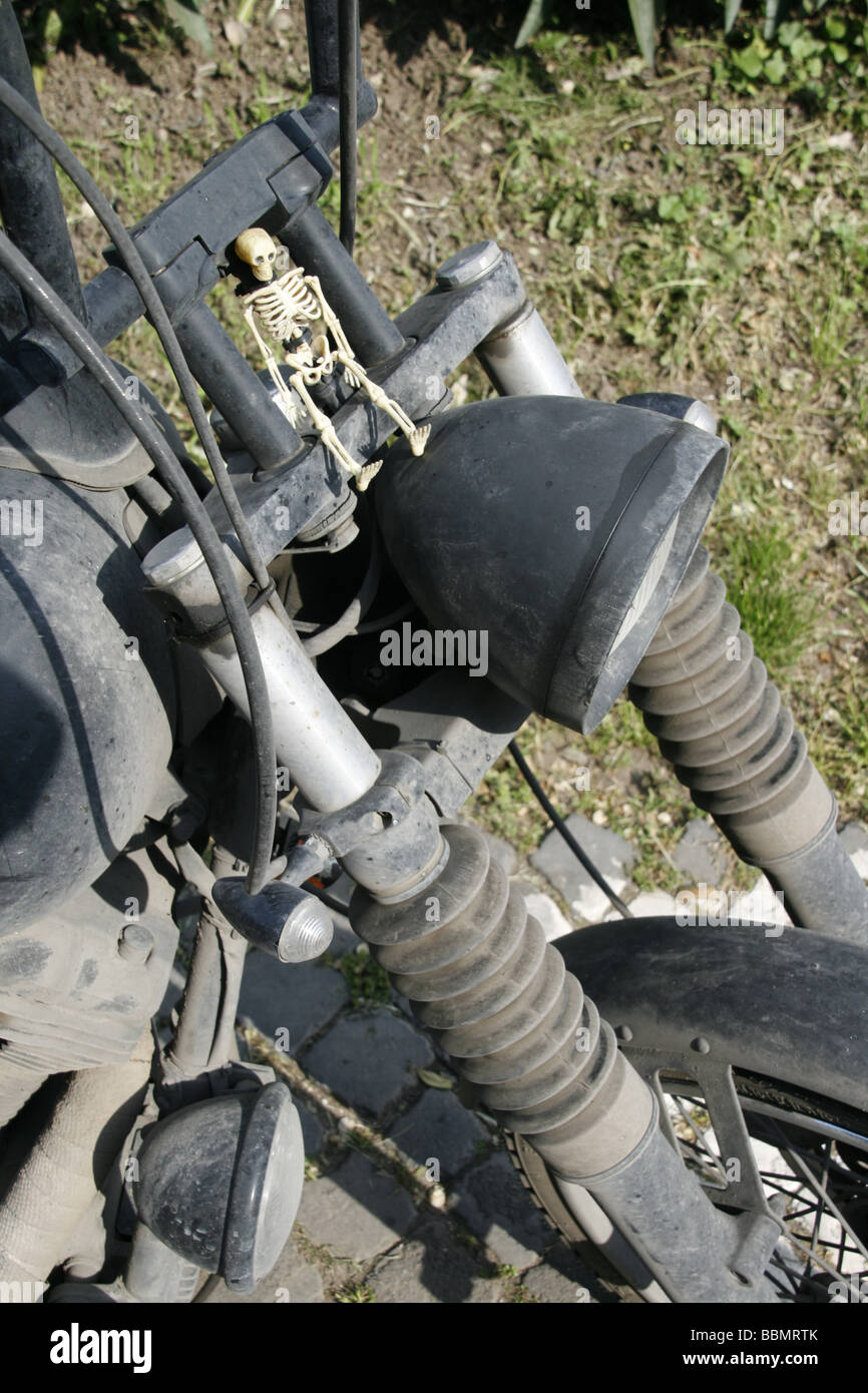 dirty harley davison motorbike with toy plastic skeleton Stock Photo