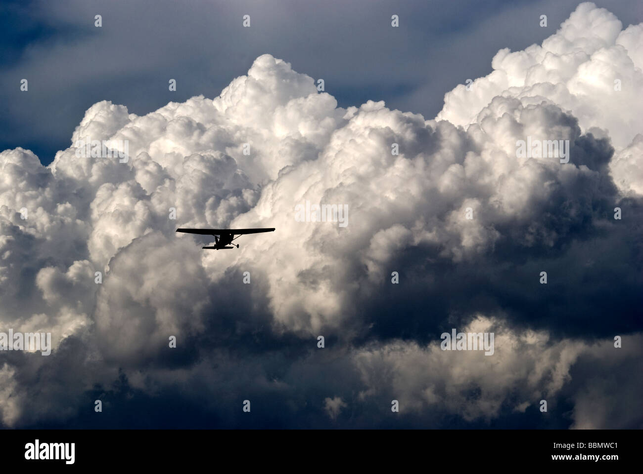 A small aircraft takes off into a gathering storm Stock Photo - Alamy