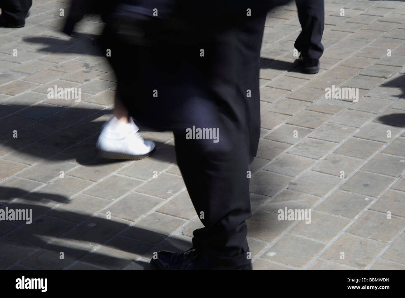 Blurred legs portraying movement, Shoppers in Leeds City Centre, Northern England Stock Photo