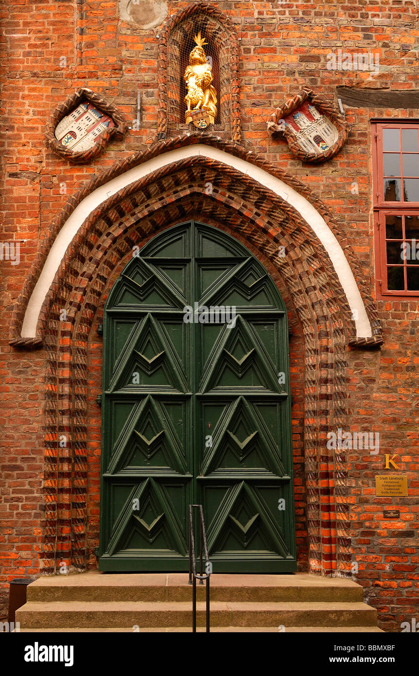 Gothic brick-lined side portal of the town hall with coat of arms and golden figure, Lueneburg, Lower Saxony, Germany, Europe Stock Photo