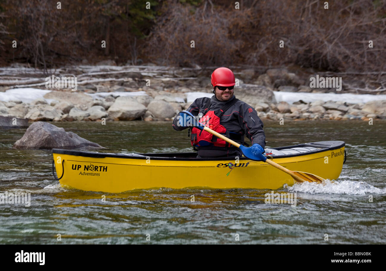 Whitewater canoeist on Takhini River, helmet, PFD, dry suit, Yukon