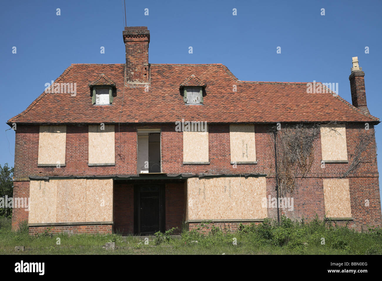 An old abandoned house with boarded up windows Stock Photo