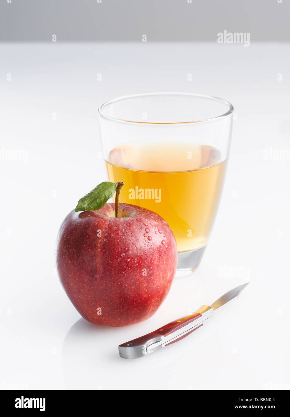 Jonagold apple, knife and glass of apple juice Stock Photo Alamy
