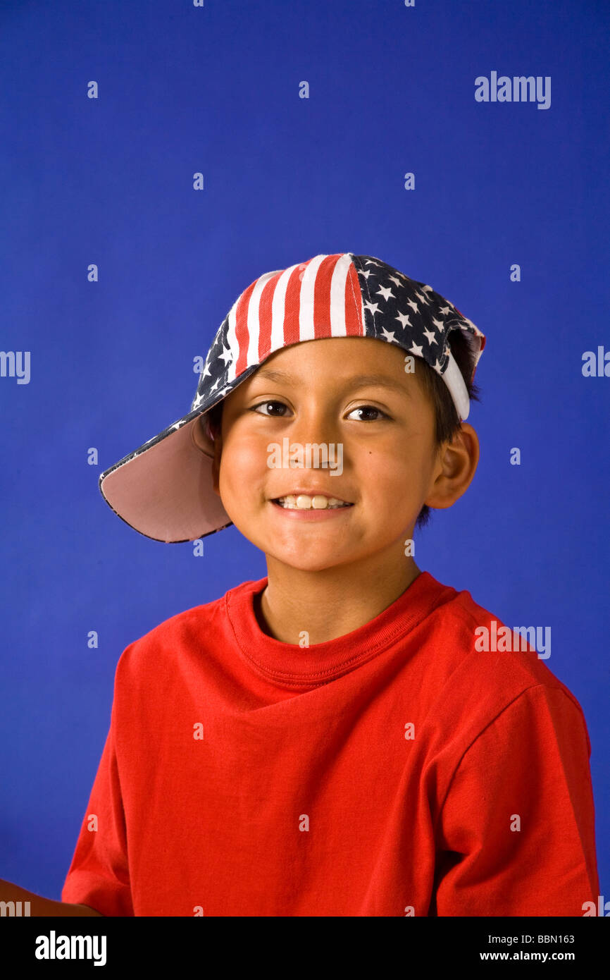Portrait of young Hispanic boy 6-8 year old wearing red white blue stars and stripes hat, USA US United States America cut out MR  © Myrleen Pearson Stock Photo