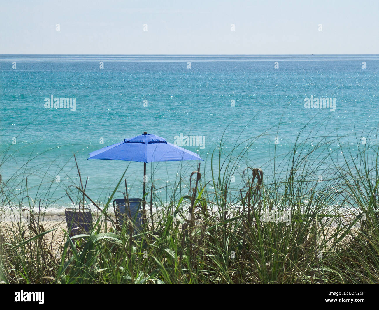 beach umbrella with water in background Stock Photo