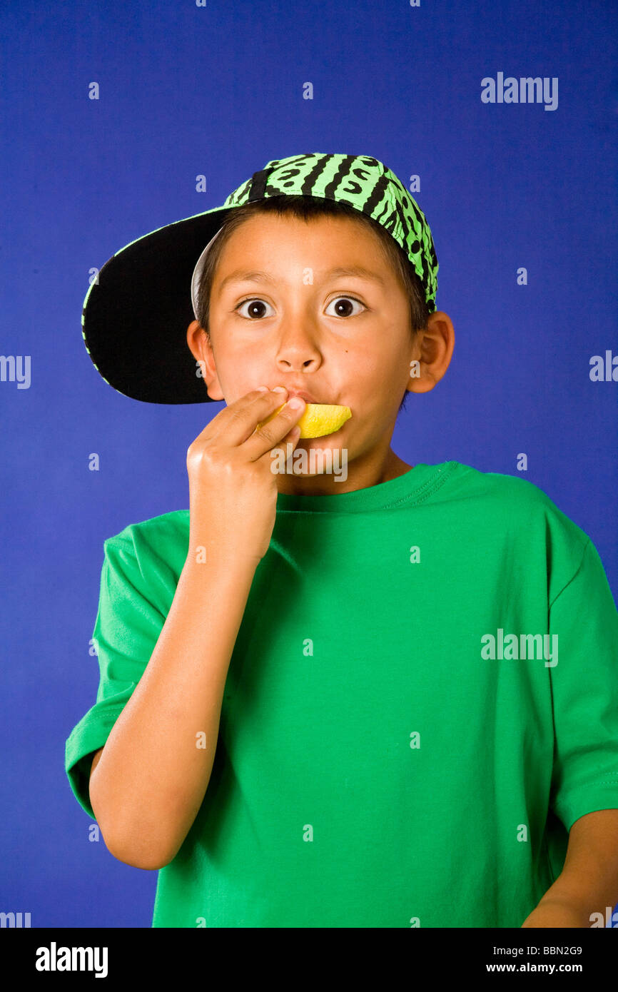 Portrait of young Hispanic boy sucking on sour lemon, big brown eyes surprised surprise expressive  studio shot cut out MR  © Myrleen Pearson Stock Photo