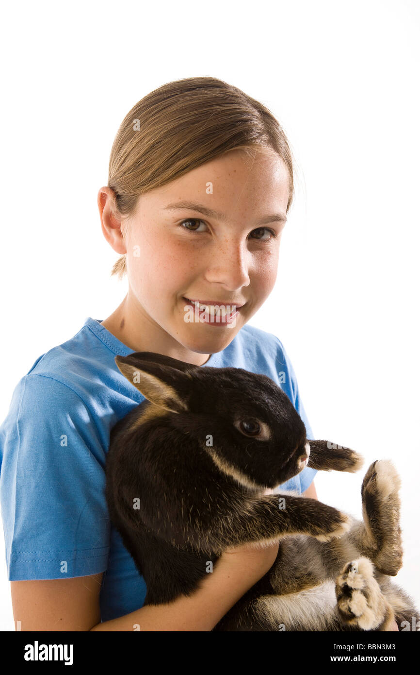 A little girl holding her rabbit with a laugh Stock Photo - Alamy