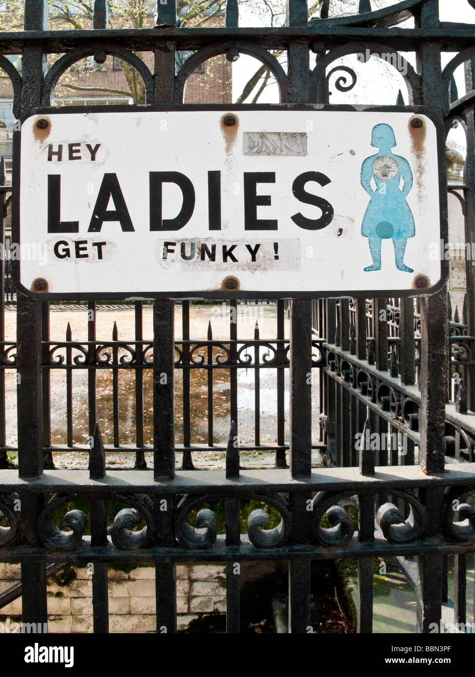 Defaced Ladies toilet sign. Lambs Conduit Street, Bloomsbury, London, England, UK Stock Photo