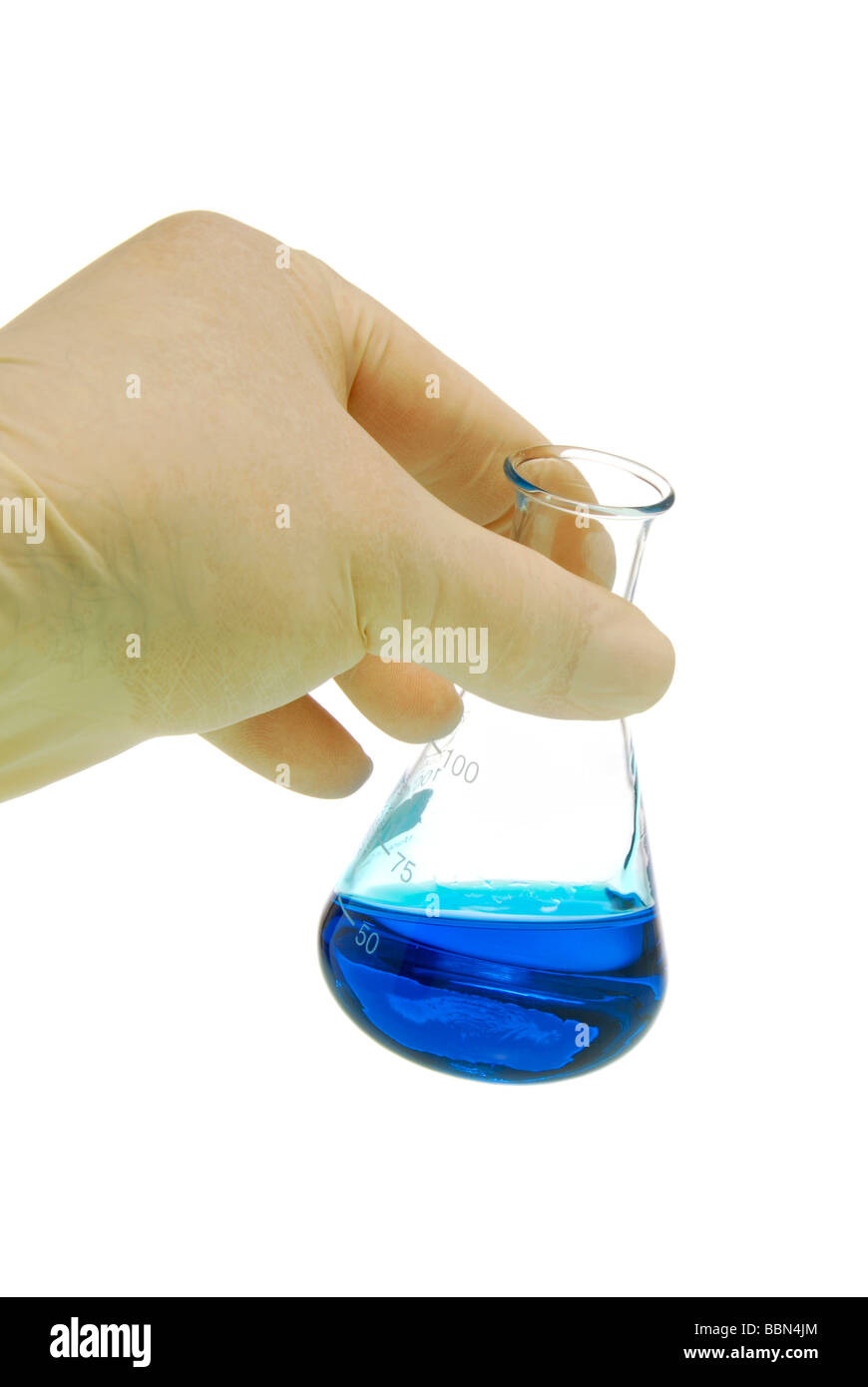 Hand with glove and glass with blue liquid, symbolic picture for chemical analysis Stock Photo