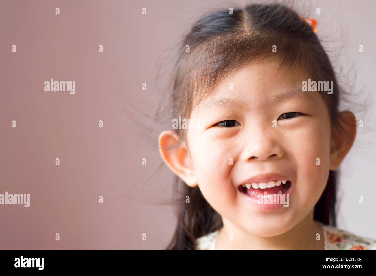 Little Asian girl with smile on her face Stock Photo - Alamy