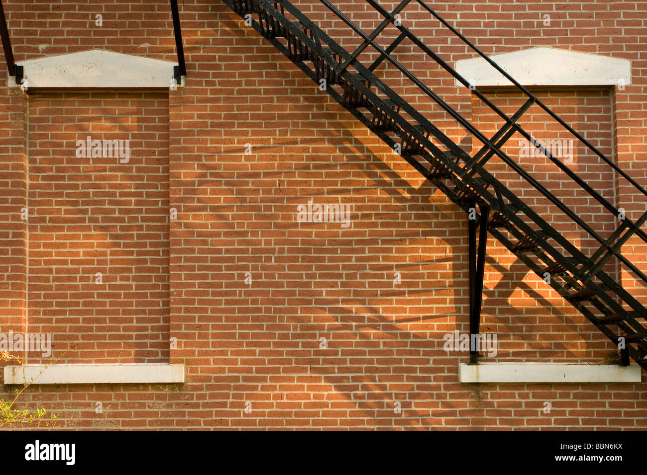Bricked-in windows and black iron fire escape staircase, Mitchell County Corthouse, Osage IA Stock Photo