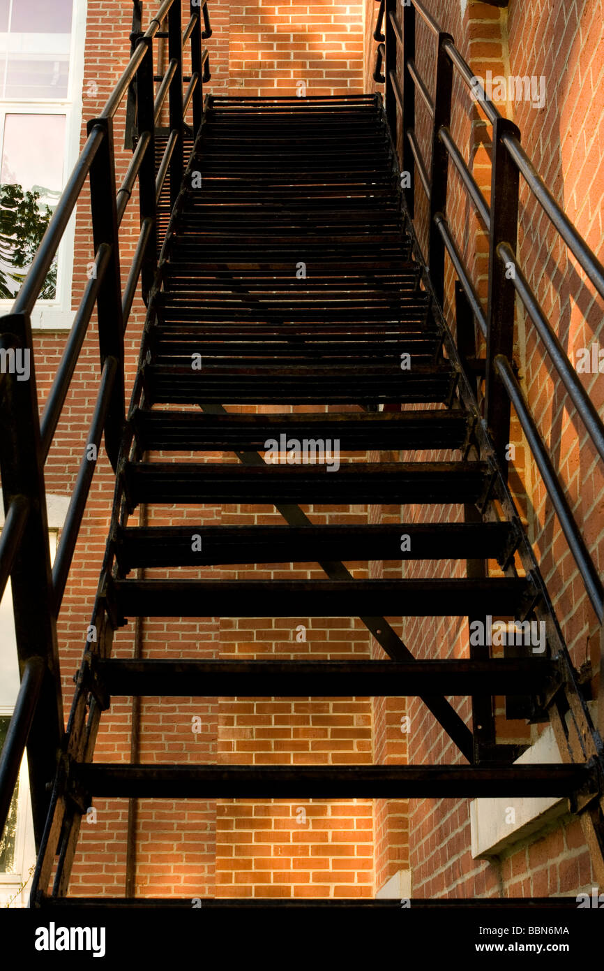 Black iron fire escape staircase along side of building, Mitchell County Corthouse, Osage IA Stock Photo