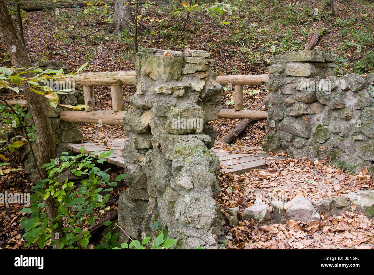 Wood and stone pedestrian bridge on hiking trail in Palisades Kepler State Park near Mt Vernon IA Stock Photo