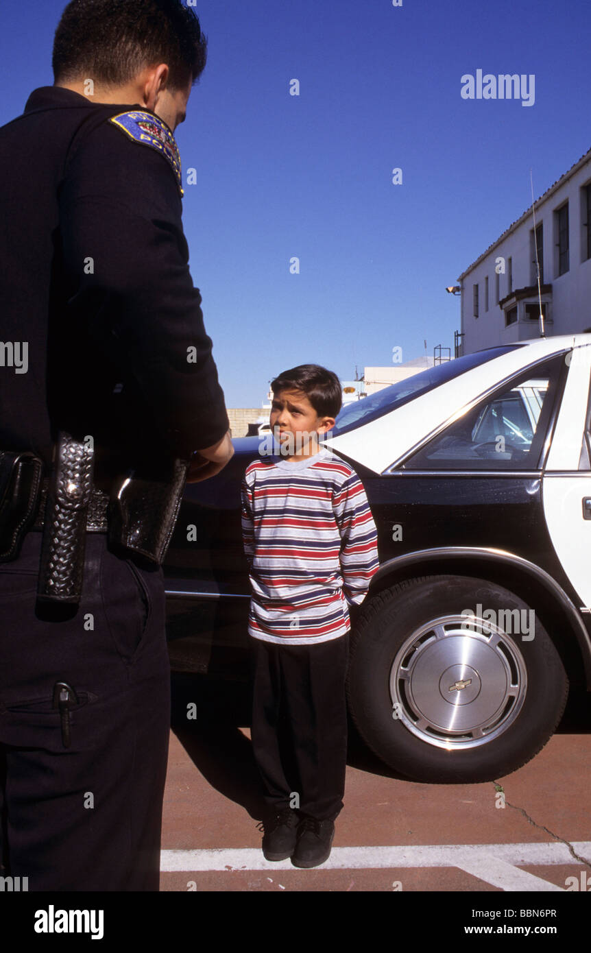 police boy scold trouble scare attention obey bad law legal cop government protect serve question care interview talk warn Stock Photo