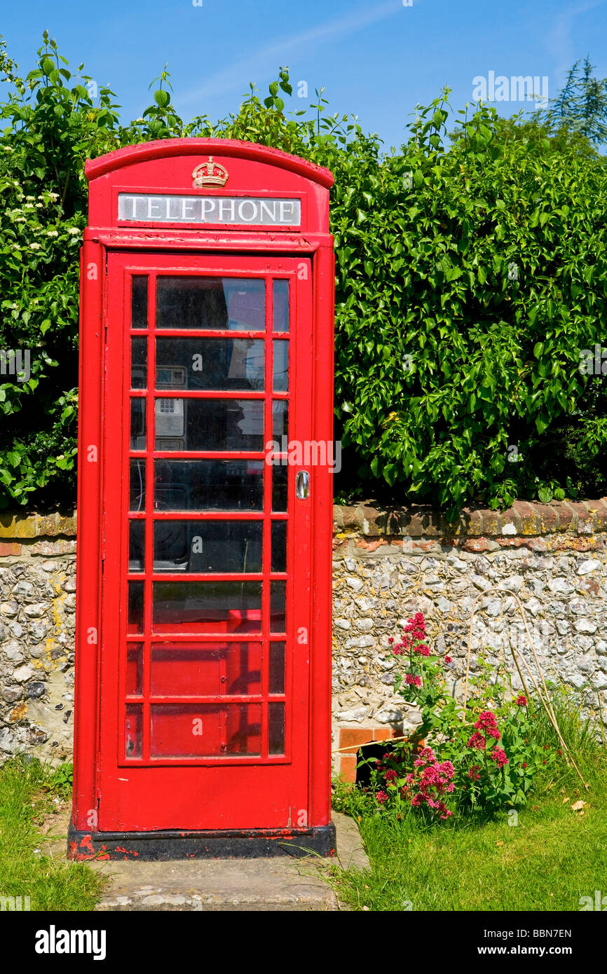 Traditional English red telephone box in country lane at East Dean, West Sussex, UK Stock Photo