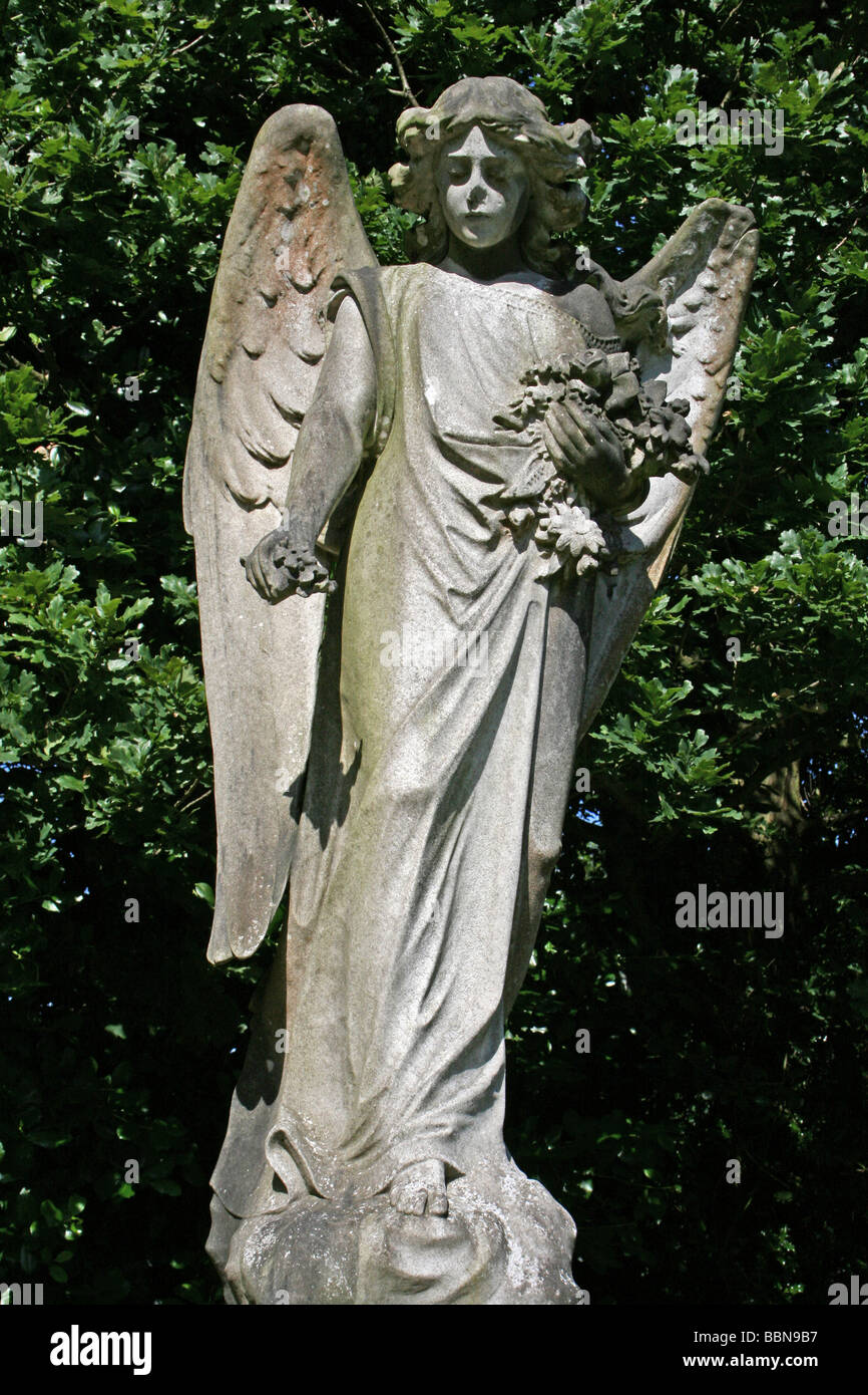 Gravestone Of Angel Holding Flowers In Flaybrick Memorial Cemetery Gardens, Bidston Hill, The Wirral, Merseyside, England, UK Stock Photo