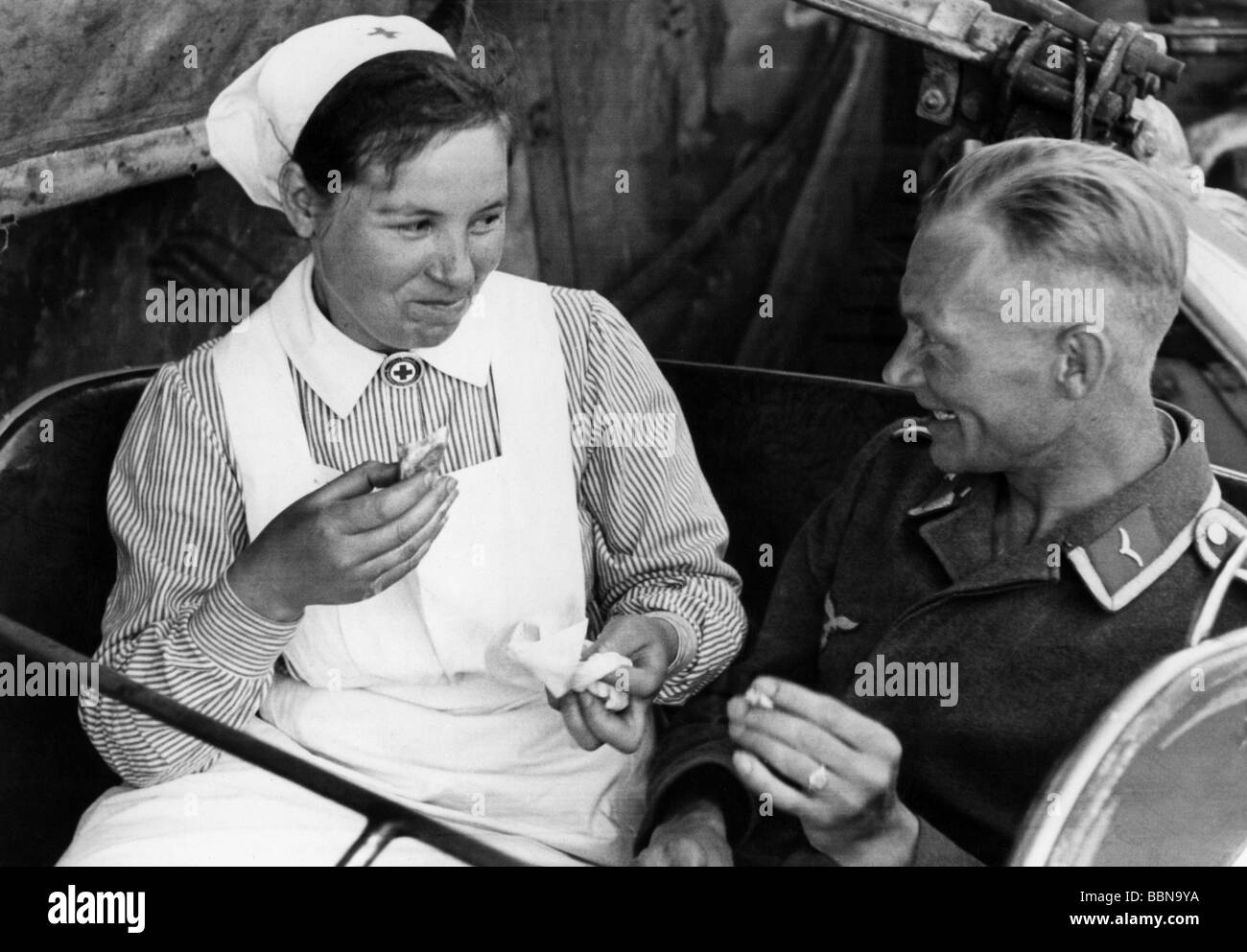 events, Second World War / WWII, Germany, medical service, nurse with a wounded German soldier in an amusement park, Germany, 1941, Stock Photo