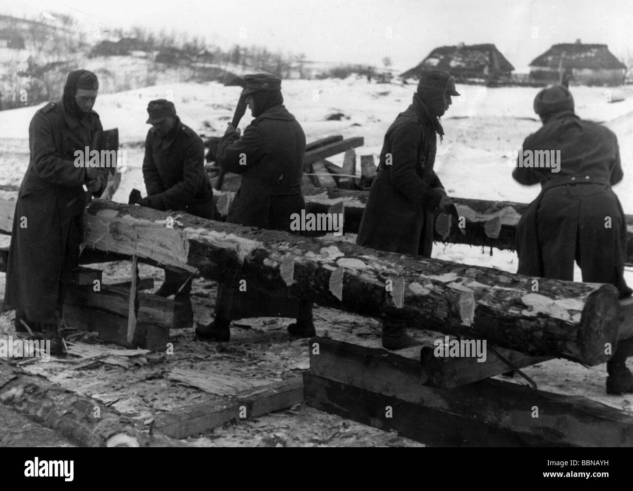 events, Second World War / WWII, Russia 1944 / 1945, sappers of a German mountain unit repairing a damaged railway line, Britskoye area, Ukraine, early 1944, military engineers, engineer, rail, Wehrmacht, Third Reich, Soviet Union, USSR, Eastern Front, working, wood, tree trunk, trunks, railroad tie, ties, axe, axes, village, houses, snow, winter, 20th century, historic, historical, people, 1940s, Stock Photo