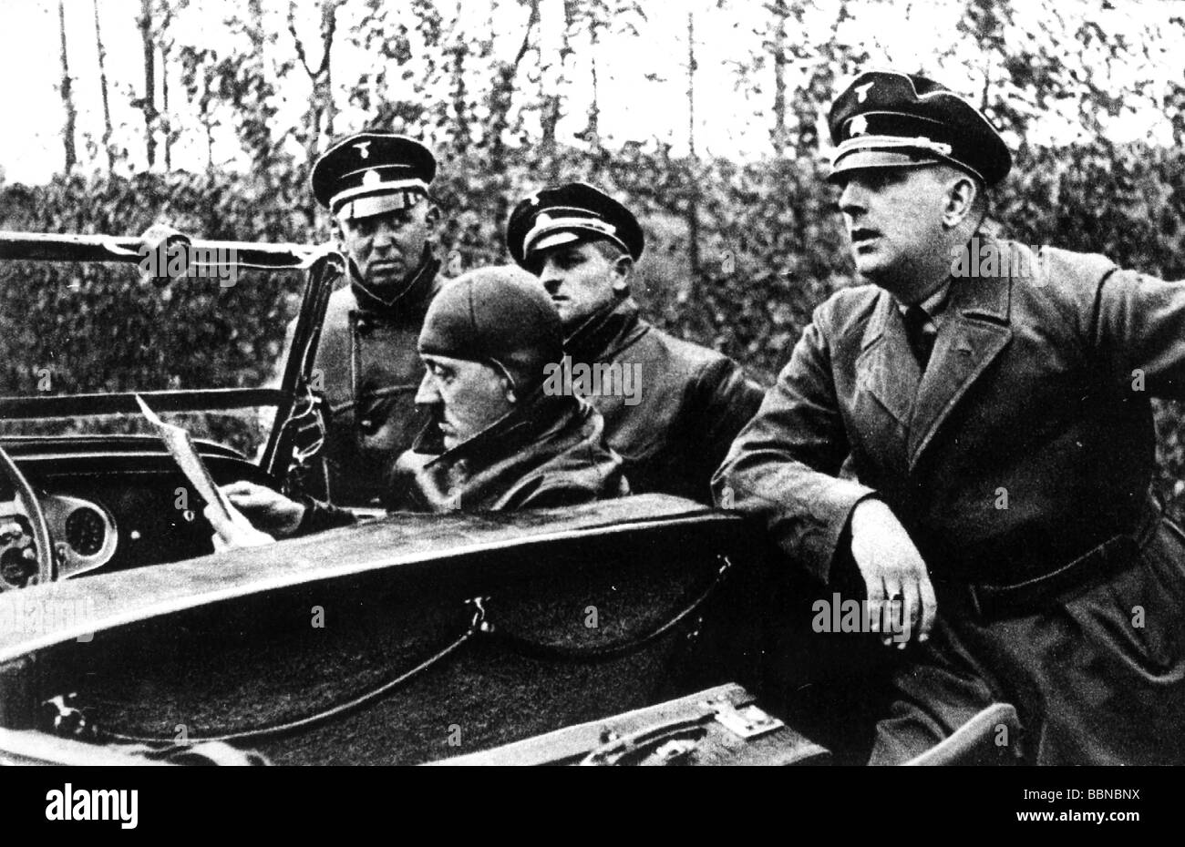 Hitler, Adolf, 20.4.1889 - 30.4.1945, German politician (NSDAP) Chancellor since 30.1.1933, in car, orientating with map, during break, with member of SS security force (RFSS / RSD), circa 1934, Stock Photo