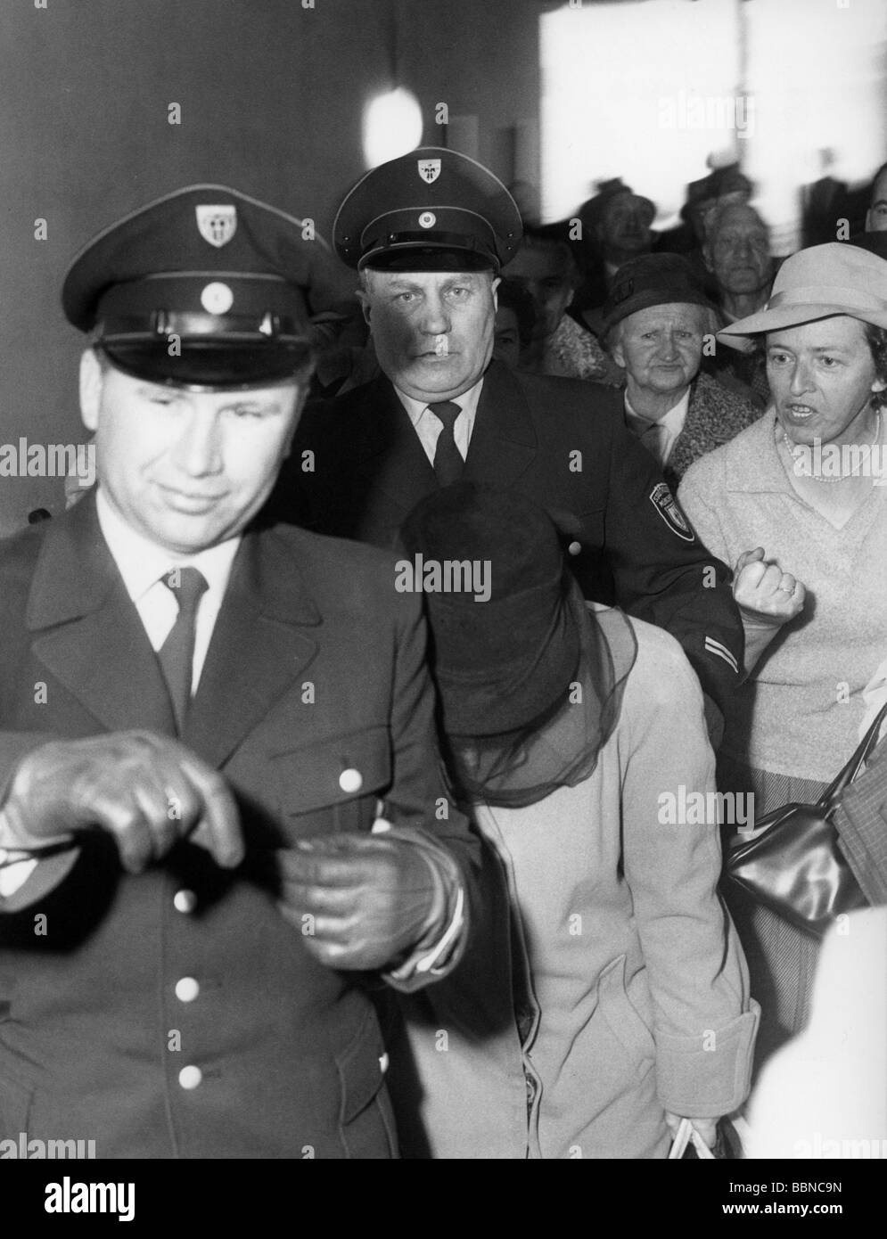 Heyde, Werner, 25.4.1902 - 13.1.1964, German physician, his wife Erika, trial because of fraud, Munich, 11.4.1961, is escorted by police from court, , Stock Photo