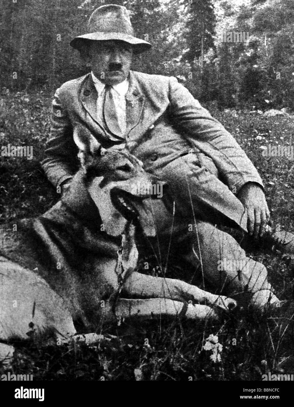 Hitler, Adolf, 20.4.1889 - 30.4.1945, German politician (NSDAP) Chancellor since 30.1.1933, half length, with German shepherd dog, resting on mountain meadow, 1930s, Stock Photo