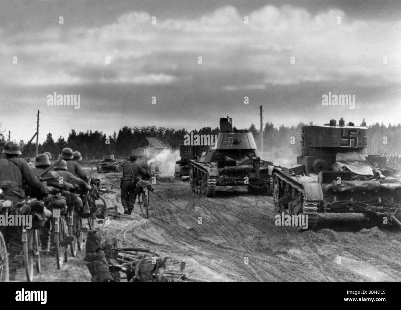 events, Second World War / WWII, Finland, Karelia, Finnish soldiers with captured Soviet light tanks T-26 advancing, probably 1941, bicycle squadron, bicycles, 20th century, historic, historical, military, Finnish national emblem, swastika, swastikas, road, uniforms, uniform, steel helmets, T26, T 26, Continuation War 1941 - 1944, people, 1940s, Stock Photo