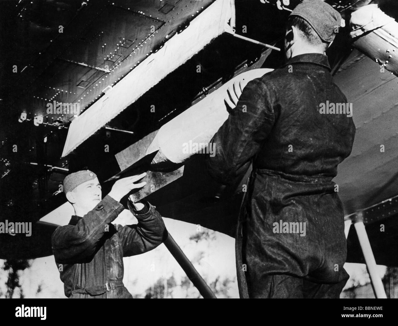 events, Second World War / WWII, aerial warfare, bombs / bombings, bomb is being loaded into the bay of a German plane, circa 1940, Stock Photo
