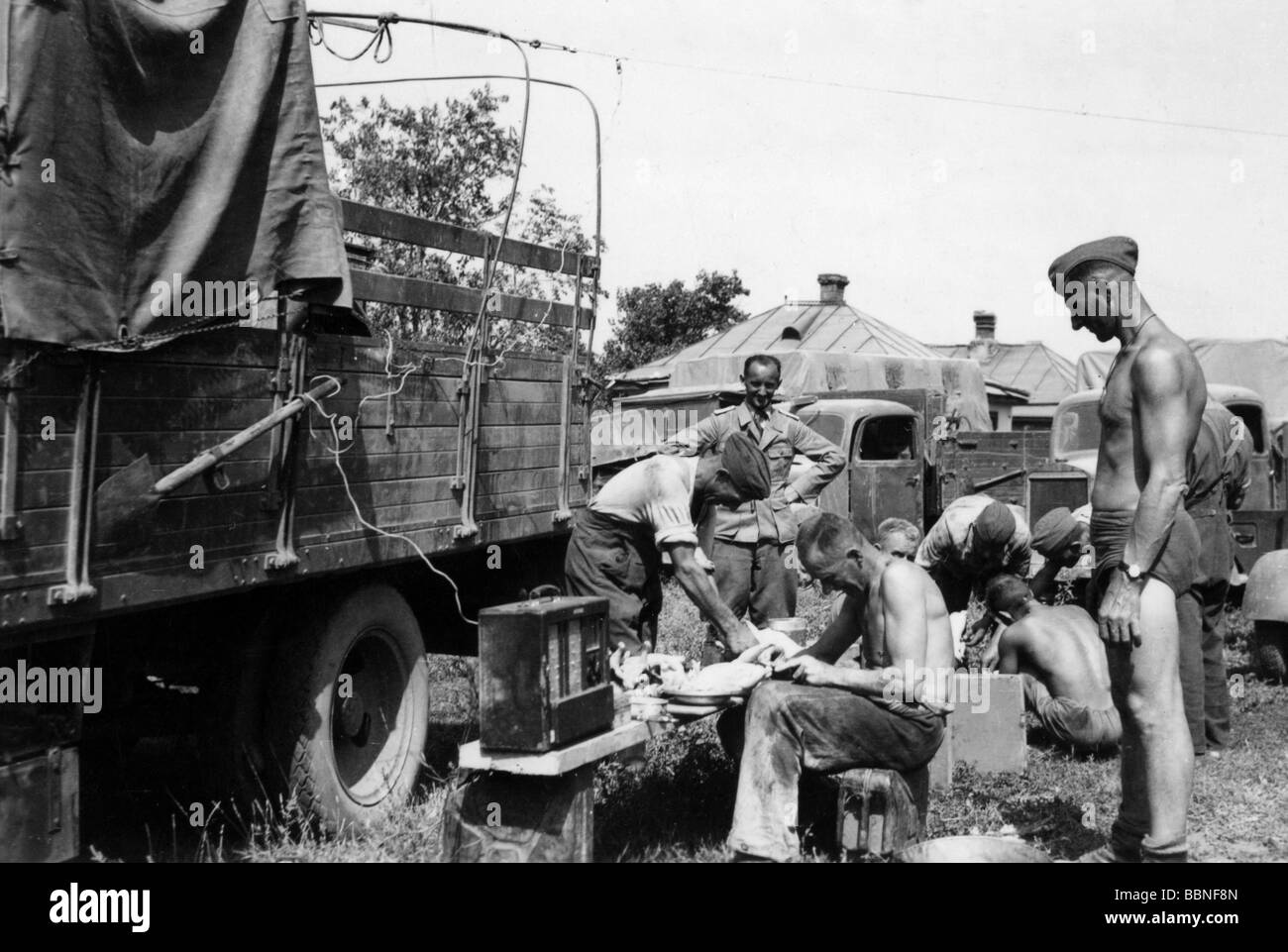 events, Second World War / WWII, Russia 1942 / 1943, soldiers of a German supply battalion in a village at the Kuban river, summer 1942, Wehrmacht, 20th century, historic, historical, supplies, unit, logistics, Third Reich, Soviet Union, USSR, baggage, Eastern Front, lorry, lorries, radio, plucking poultry, occupation, people, 1940s, Stock Photo
