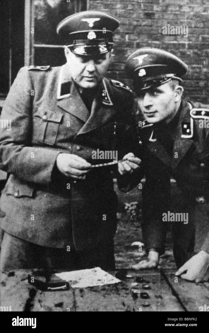 Natíonal Socialism/Nazism, crimes, Auschwitz concentration camp, guards, two NCOs of the SS with valuables of prisoners, circa 1944, Stock Photo