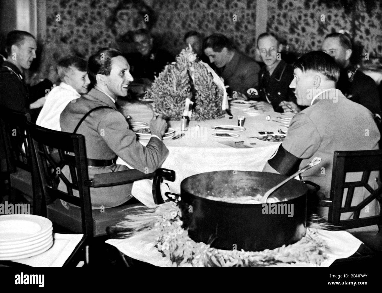 Hitler, Adolf, 20.4.1889 - 30.4.1945, German politician (NSDAP), Fuehrer and Reich Chancellor since 1933, scene, with Joseph Goebbels, eating hotpot, propaganda photo, 1930s, Stock Photo