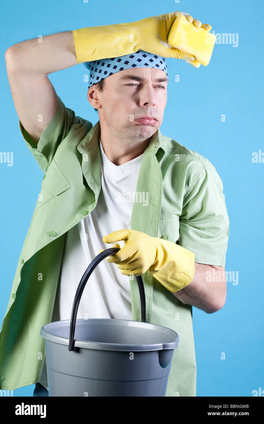 Man holding bucket and sponge, portrait Stock Photo - Alamy