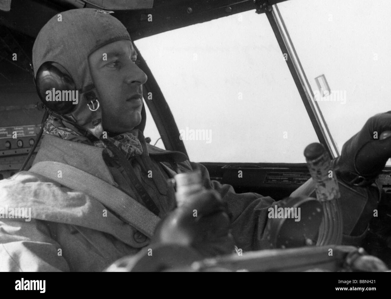 events, Second World War / WWII, aerial warfare, persons, Luftwaffe pilot in the cockpit of a bomber Heinkel 111 during a mission against Great Britain, August 1940, 20th century, historic, historical, Wehrmacht, Germany, Third Reich, soldier, soldiers, uniform, uniforms, flying cap, caps, suit, Battle of Britain, He111, He-111, steering stick, aviator, aviators, pilots, Hauptmann Lonicer, captain, England, people, 1940s, Stock Photo