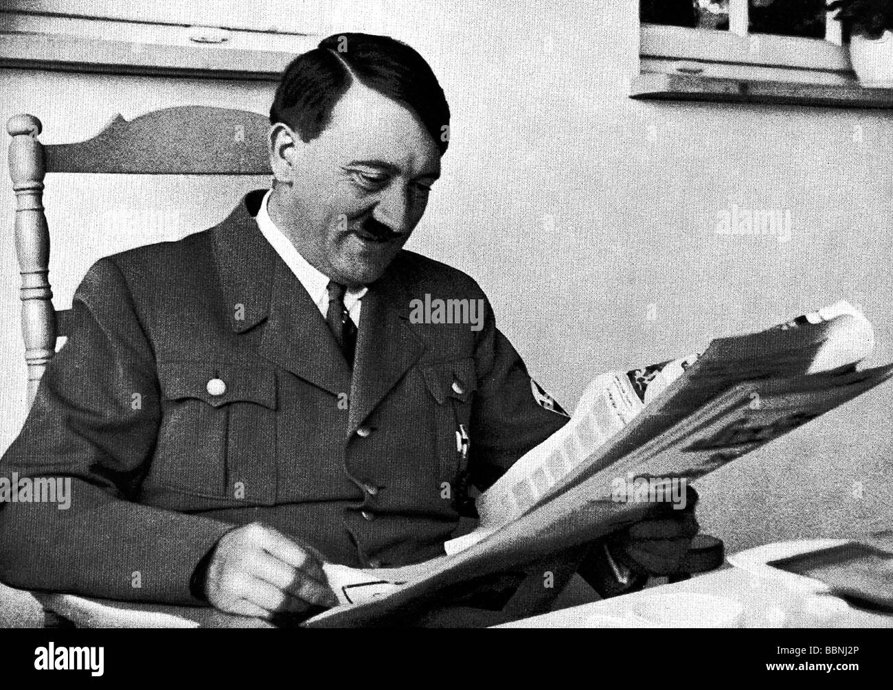 Hitler, Adolf, 20.4.1889 - 30.4.1945, German politician (NSDAP), Fuehrer and Reich Chancellor since 1933, half length, at the Berghof, reading newspaper, Stock Photo