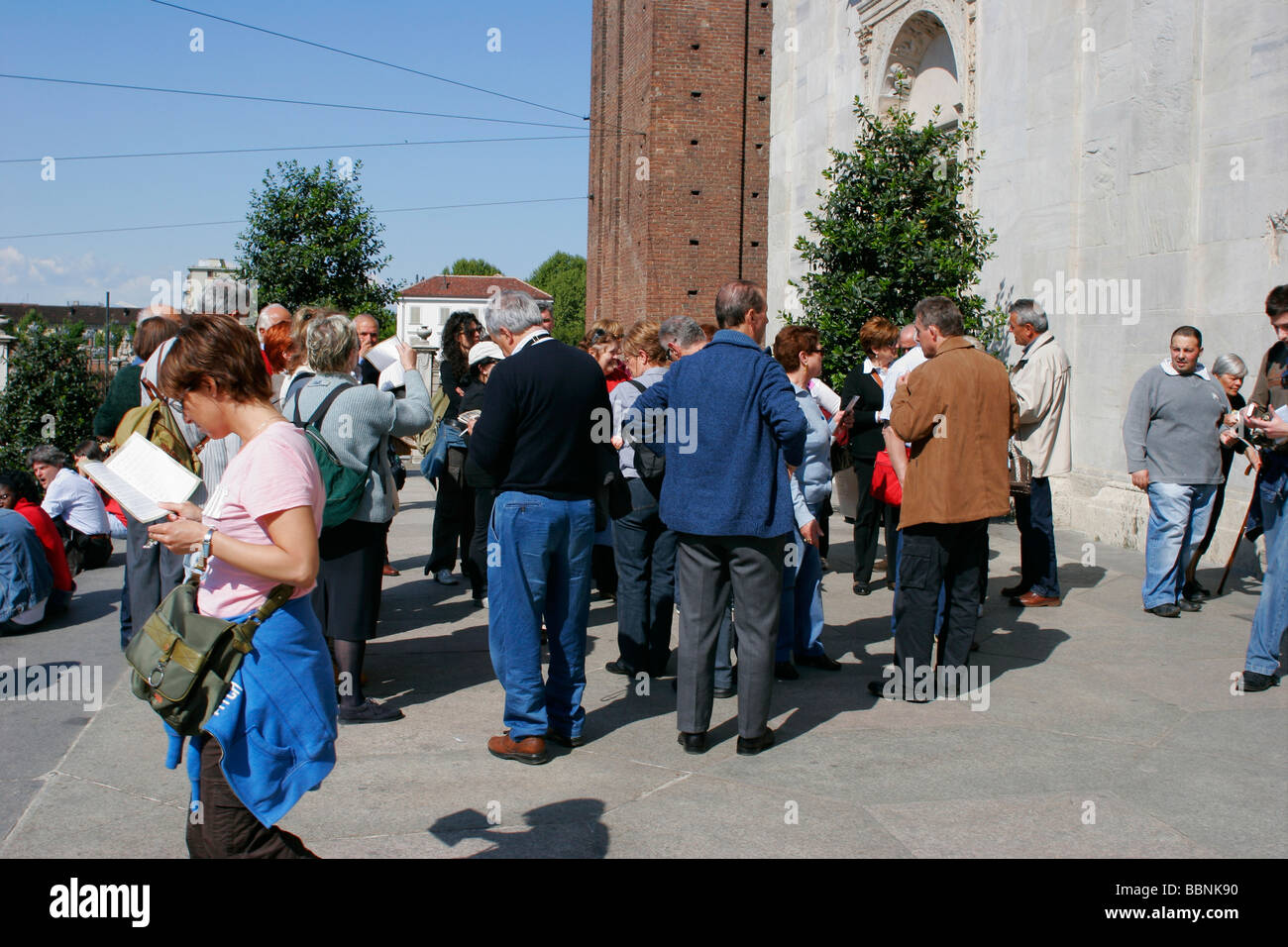 Group of tourists next to the Duomo di Torino, Italy. Stock Photo
