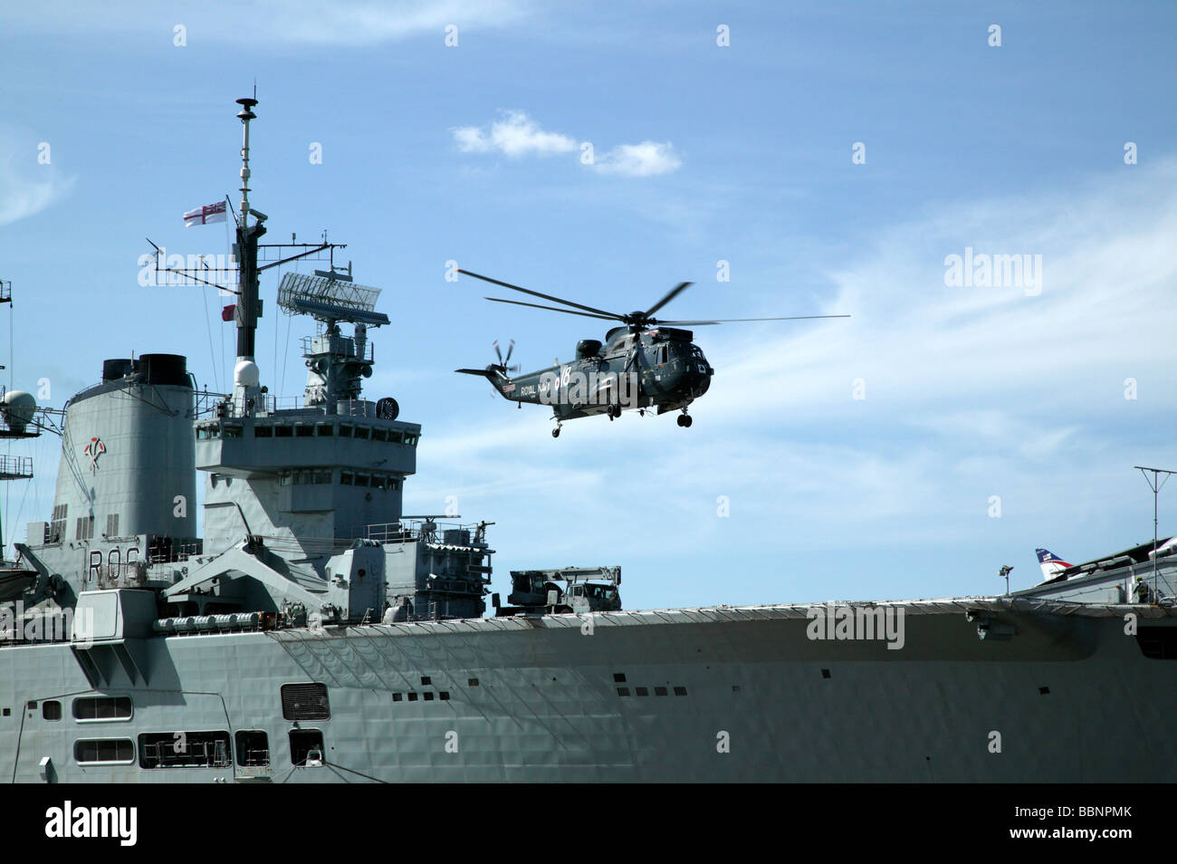 A Royal Navy Westland Sea King Helecopter takes of from the deck of  HMS Illustrious, during the Fly Navy 100 celebrations Stock Photo