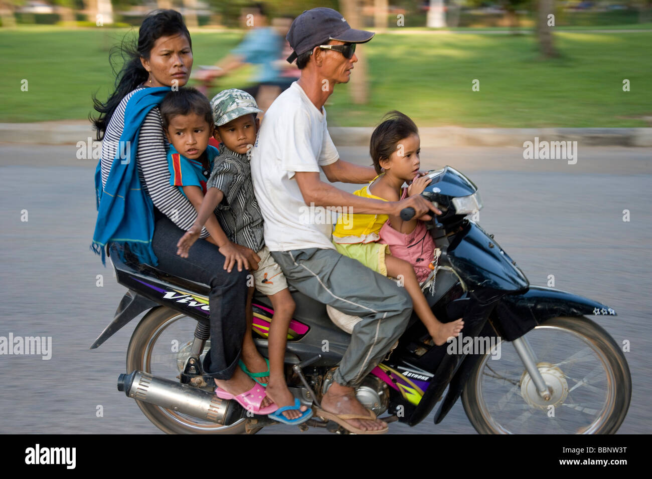 Siem Reap,Cambodia;Family riding on a scooter together without safety helmets Stock Photo