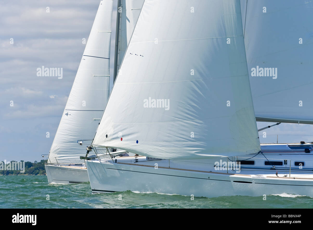 Two beautiful white yachts sailing close to each other on a bright sunny day Stock Photo