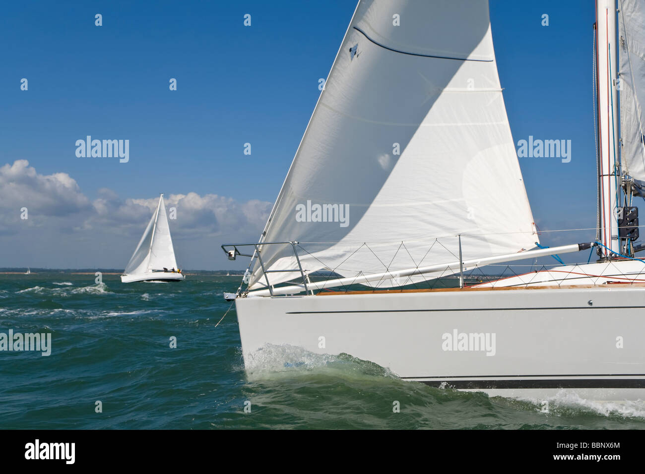Two beautiful white yachts sailing on a bright sunny day Stock Photo