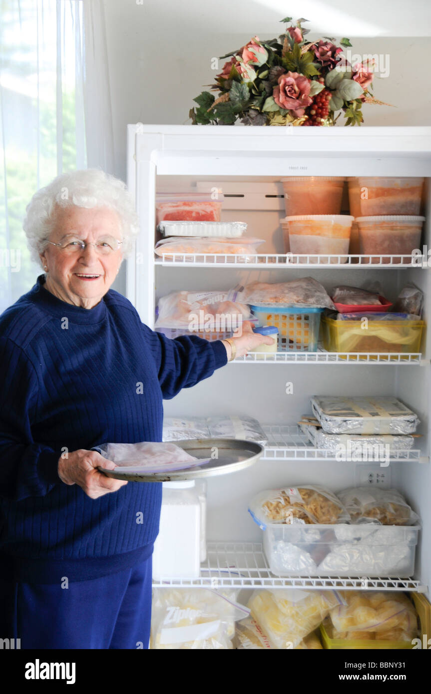 Woman Selecting Food From Freezer Stock Photo