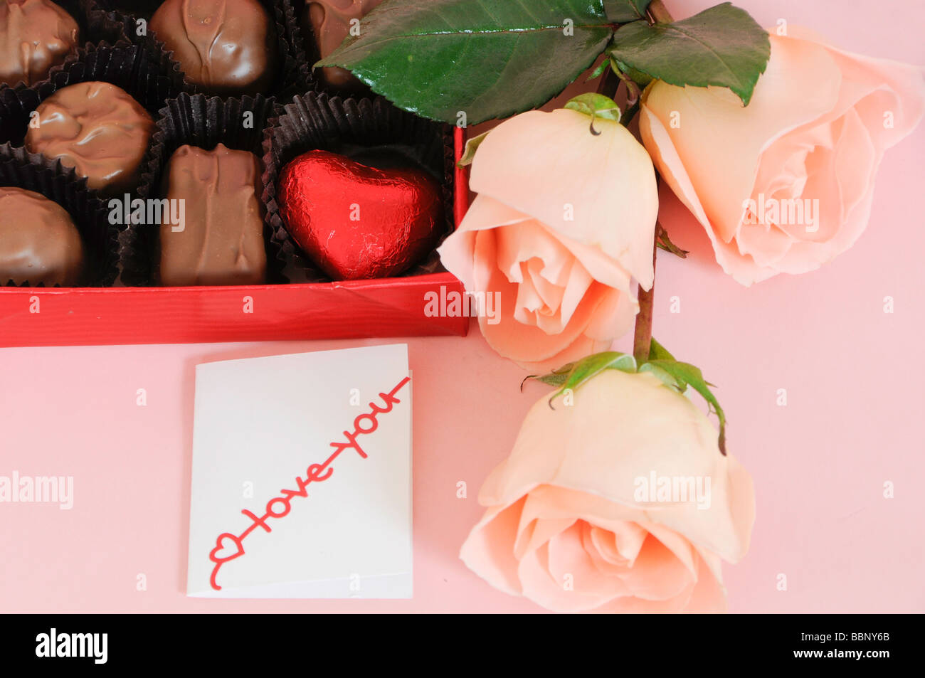 Box of Chocolates with Pink Roses and Card Stock Photo Alamy