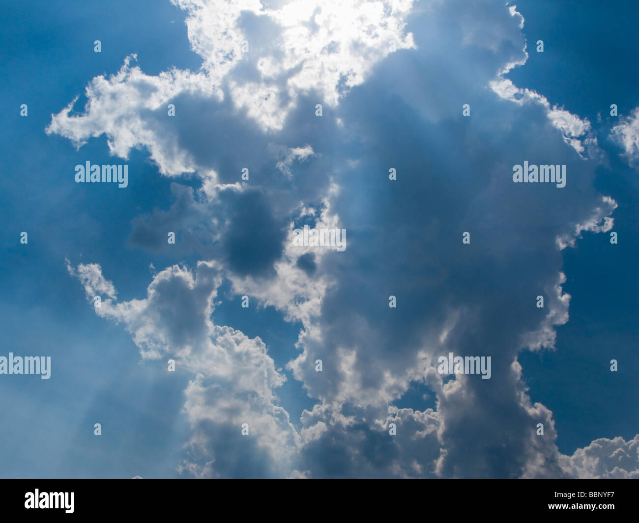 Blue sky with fluffy white clouds and sun rays Stock Photo - Alamy