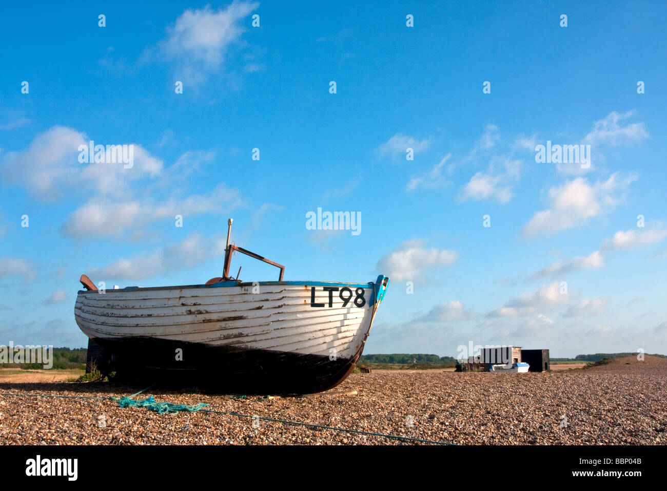 Traditional wooden fishing boat on the shingle beach at Dunwich on the ...