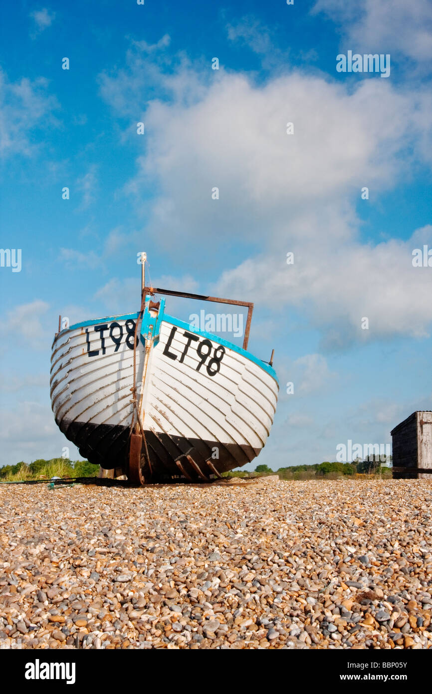 Traditional wooden fishing boat on the shingle beach at Dunwich on the Suffolk Coast Stock Photo