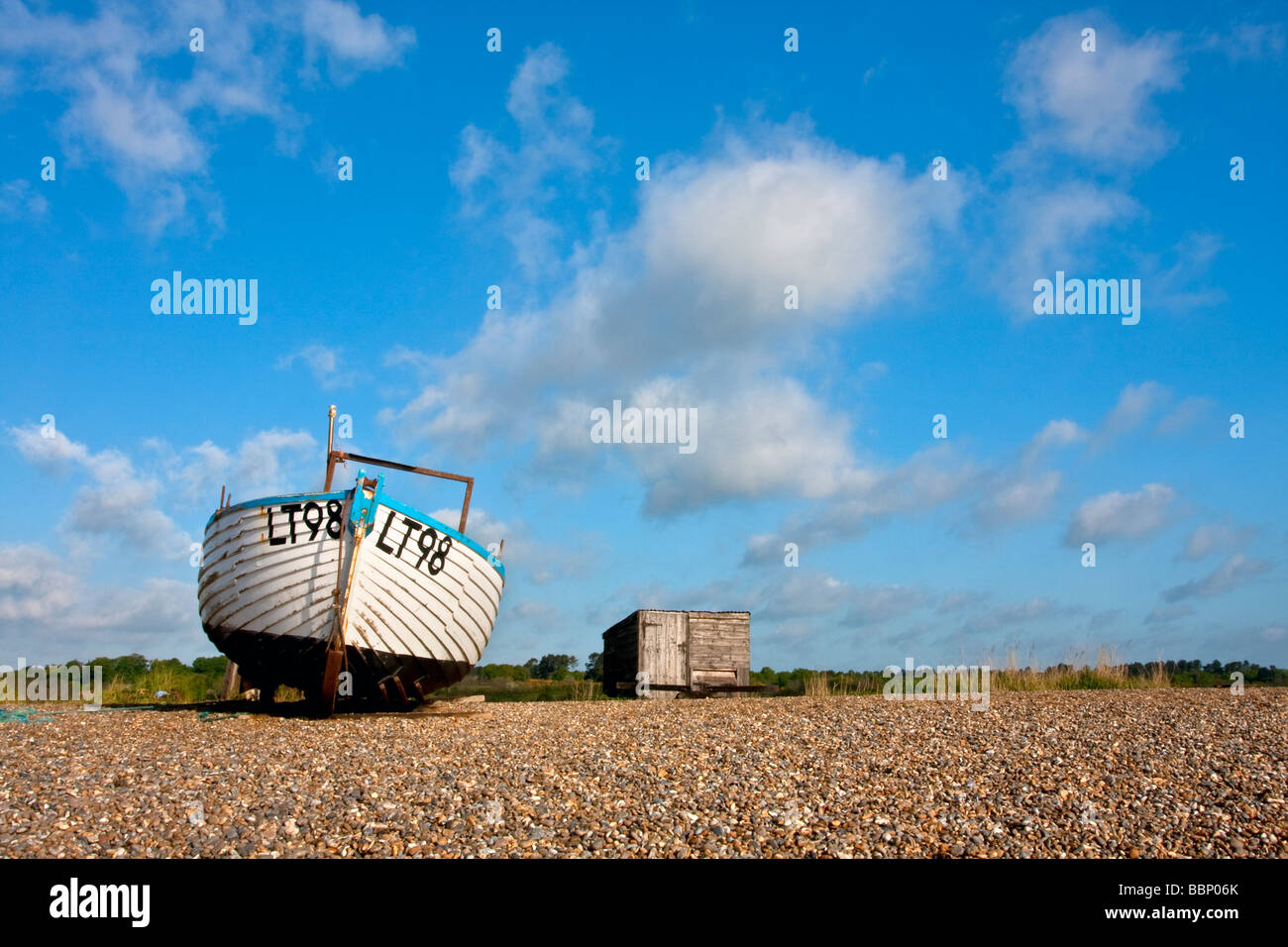 Traditional wooden fishing boat on the shingle beach at Dunwich on the Suffolk Coast Stock Photo