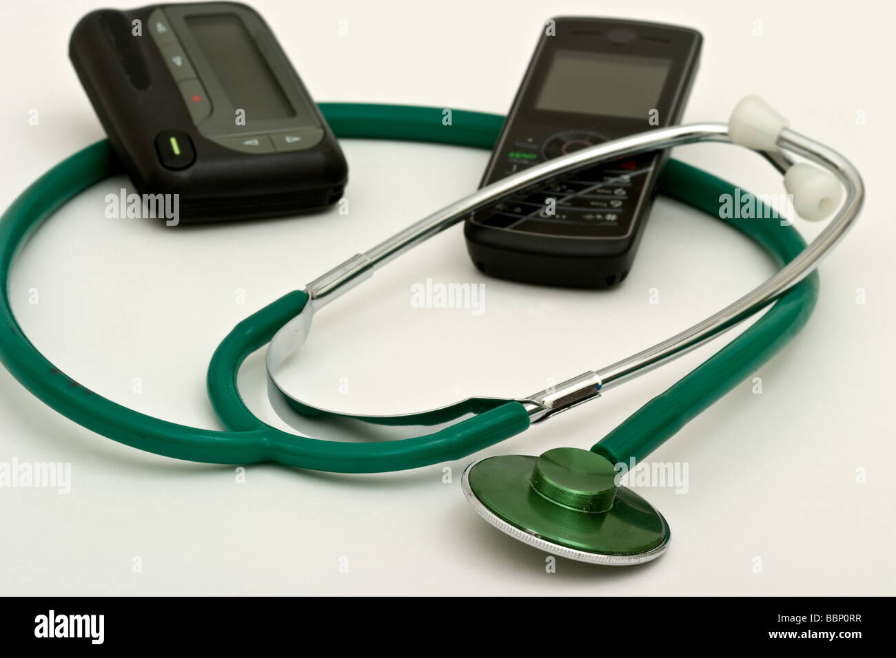 Stethoscope with a pager and a cell phone Stock Photo
