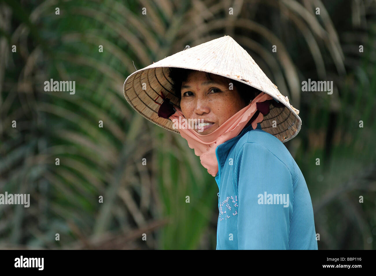 Vietnamese woman with a traditional hat, cone-shaped hat made of palm leaves, Can Tho, Mekong Delta, Vietnam, Southeast Asia Stock Photo