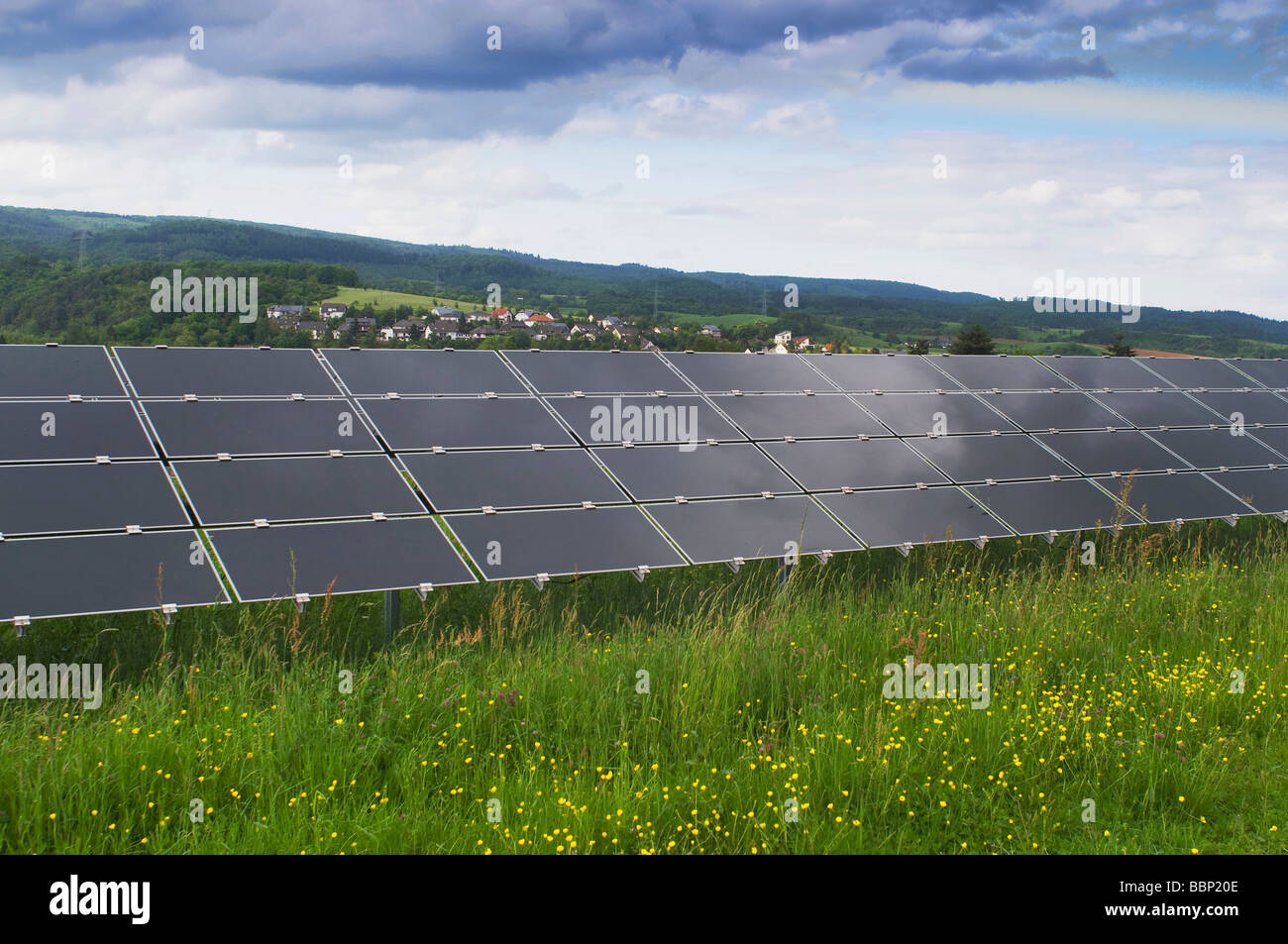 Solar power plant on a green field, photovoltaic system, view of a series of several modules Stock Photo