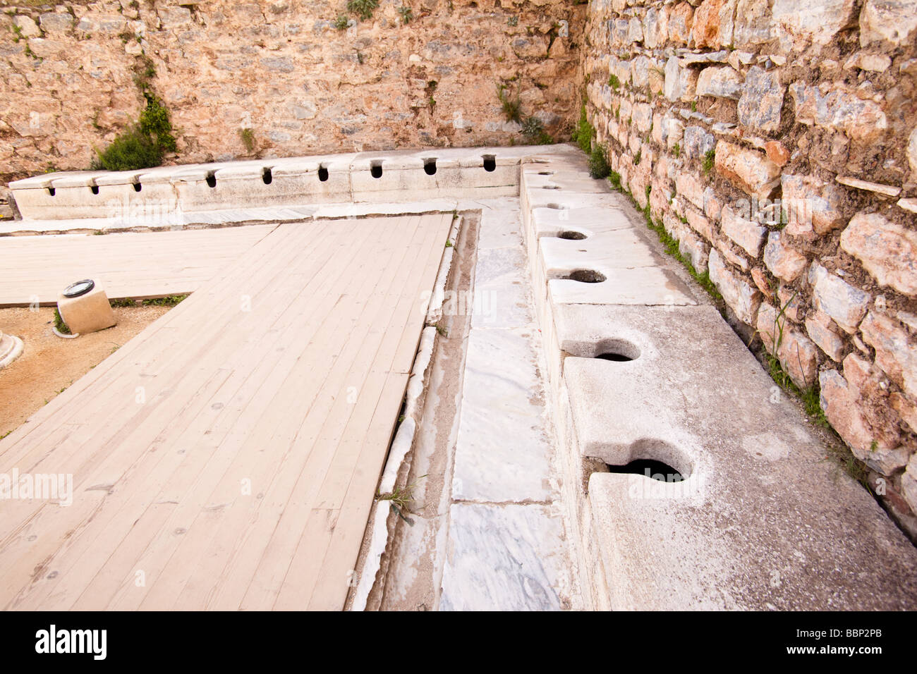 Ancient roman latrine public toilets at Ephesus in Turkey Stock Photo